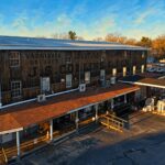 Historic J.S. Collins & Son lumber yard building at 300 Mill Street in Moorestown, New Jersey, with original painted sign for varnishes, brushes, and paints; now home to Townehaus behind Moorestown Hardware.